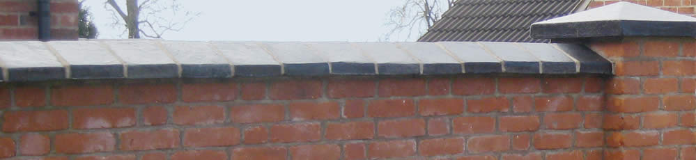 blue coping stones topping a brick wall